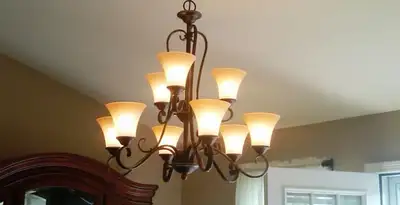 Classic ceiling chandelier installation with warm lighting in Flagstaff, AZ