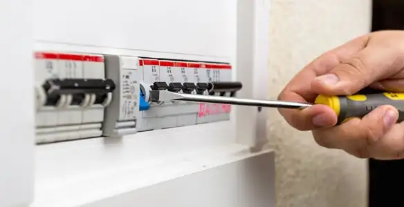 electrical panel upgrade service showing technician adjusting circuit breakers during system upgrade in Flagstaff, AZ