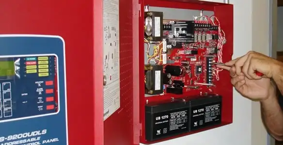 fire alarm installation service showing technician configuring fire alarm control panel in Flagstaff, AZ