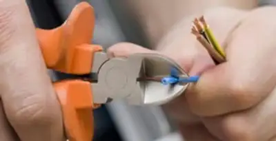 professional electrical services showing precise wire cutting by licensed electricians in Flagstaff, AZ