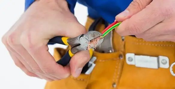 licensed electrician securing electrical wiring with professional tools during service work in Flagstaff, AZ